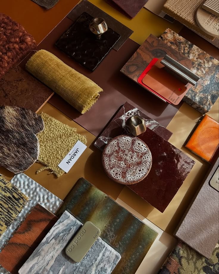 A rich material palette of burgundy stone, mustard textiles, patinated metal, wood and textured finishes